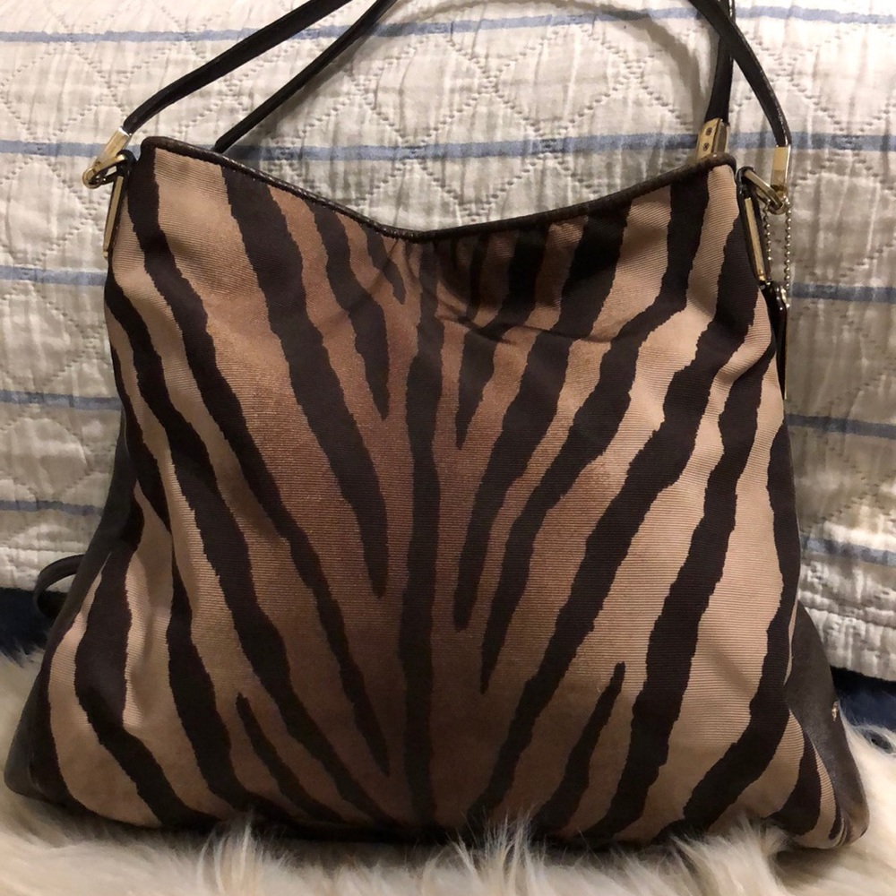Coach purse with  and brown leather.
